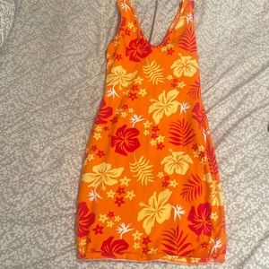 Orange fitted dress with red and yellow ish flowers.
